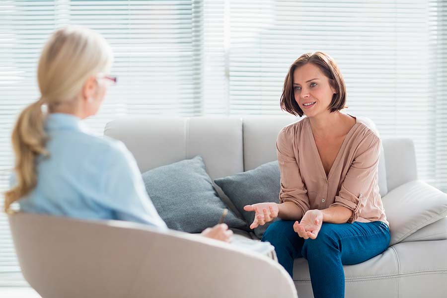 Women in an outpatient program session talking with counselor.